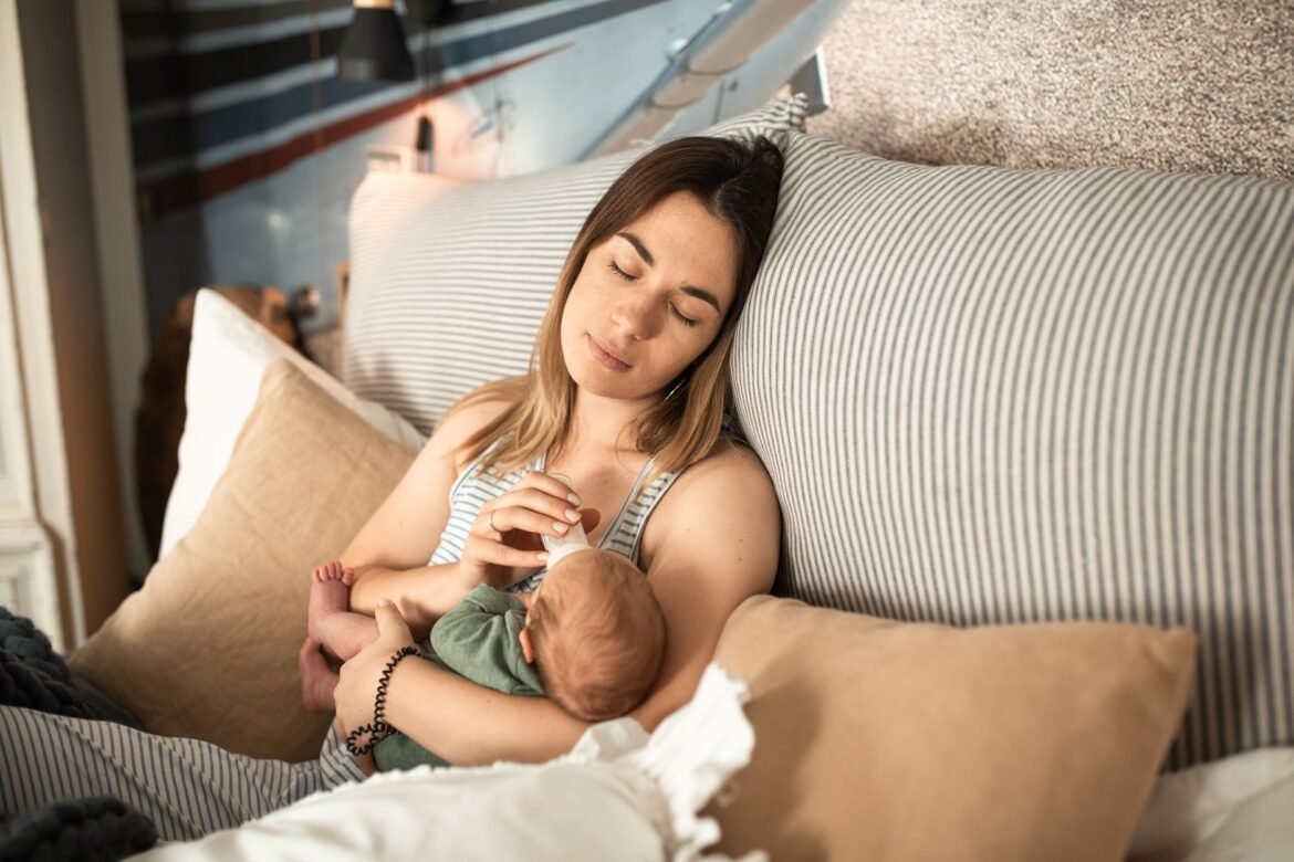 Peaceful moment of a mother and newborn baby relaxing at home.