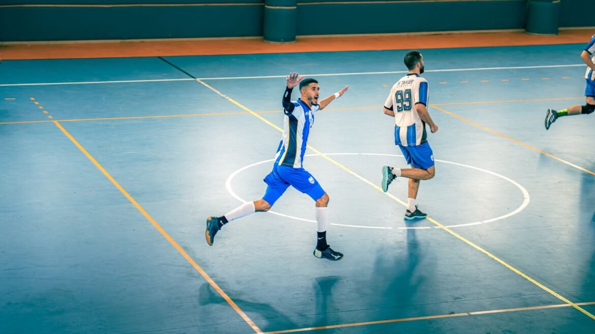 Action-packed indoor futsal game with players in motion on the court.